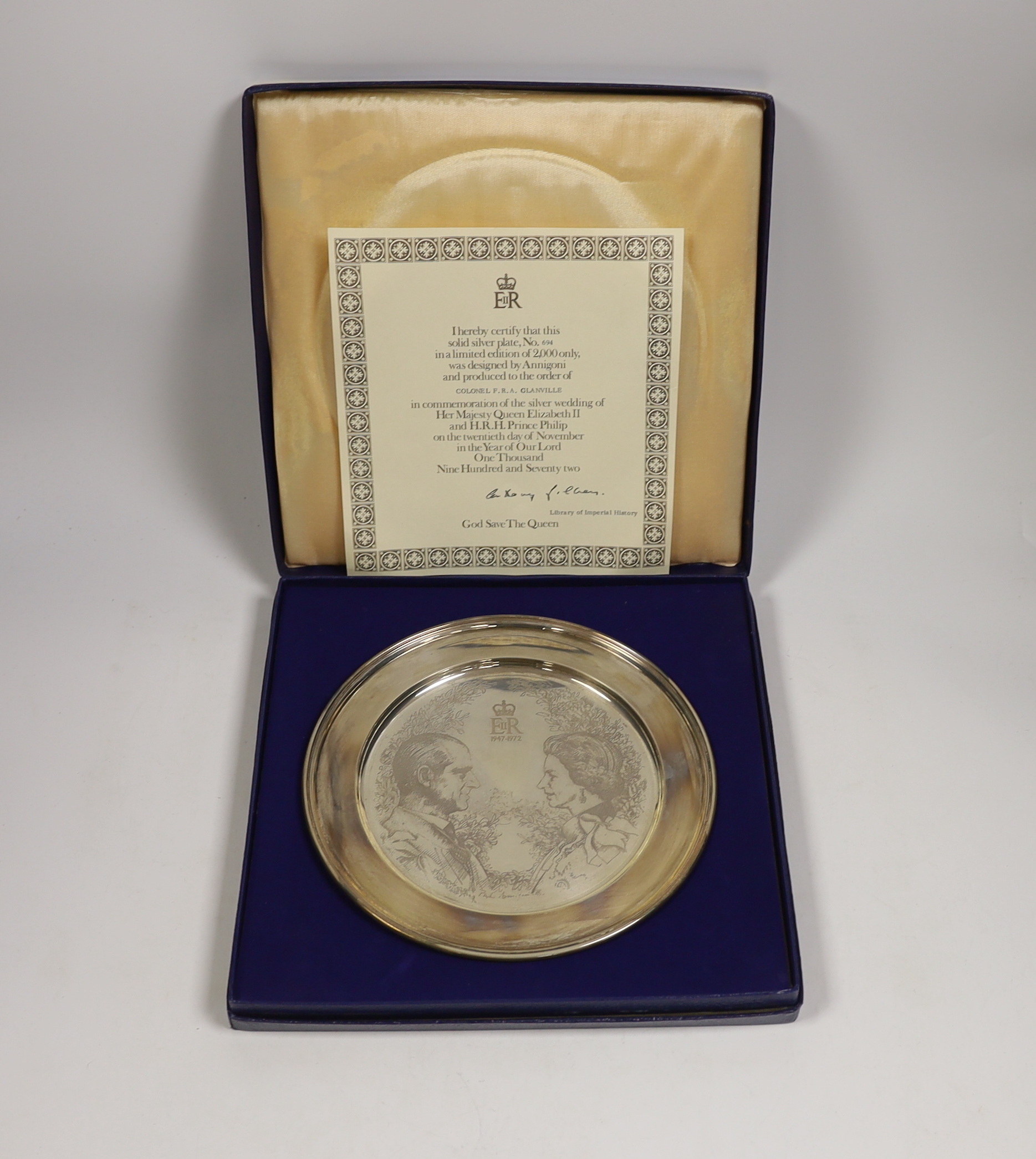 A cased limited edition silver plate commemorating the Silver Wedding of Queen Elizabeth II and H.R. Prince Philip, 1972, designed by Annigoni, William Comyns & Sons Ltd, London, 1972, diameter 22.8cm, 12.1oz.